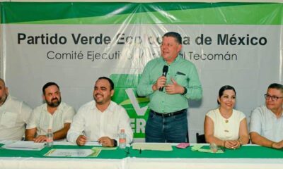 Virgilio Mendoza, dirigente del PVEM en Colima, con una lona del partido